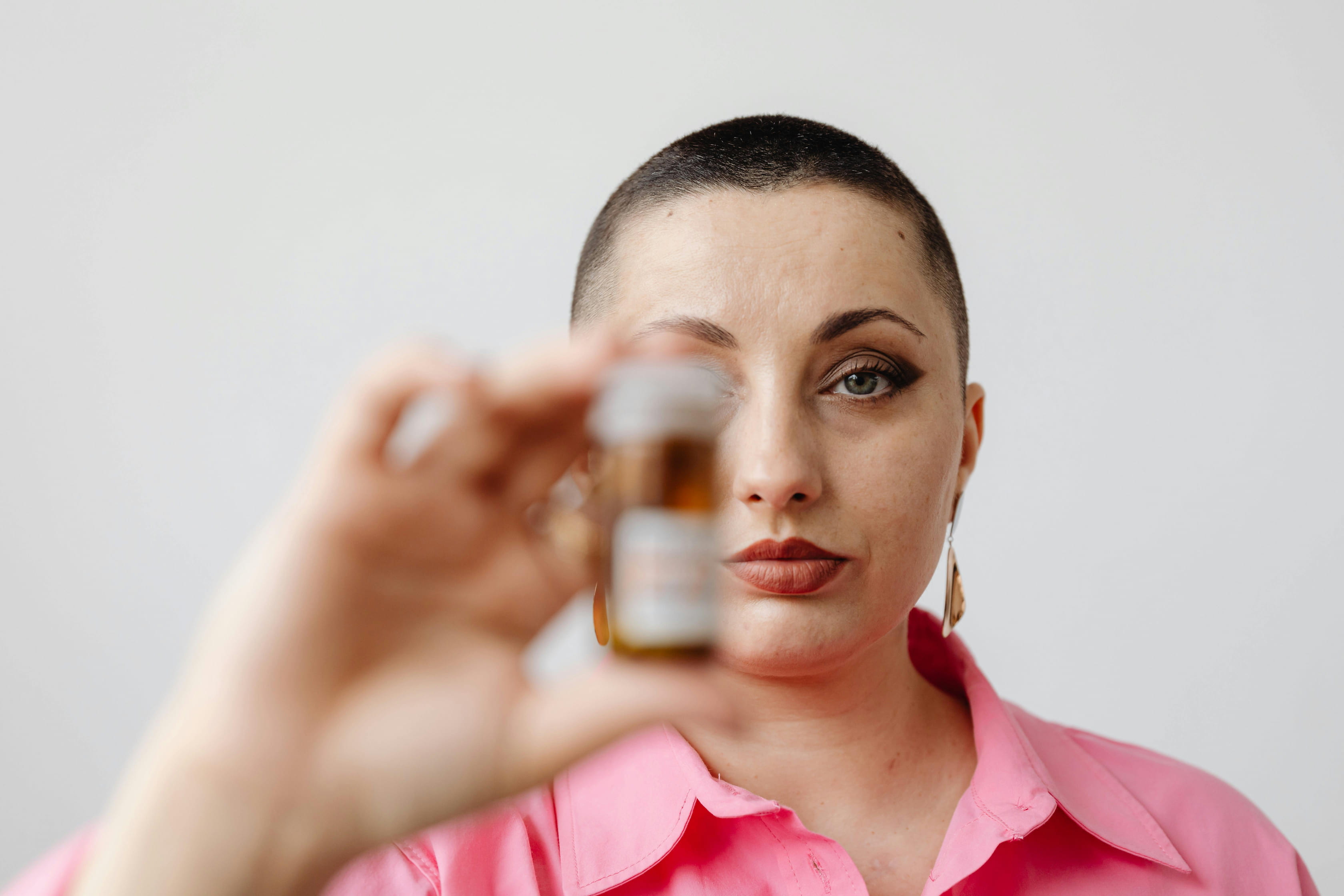A woman holds a pill bottle